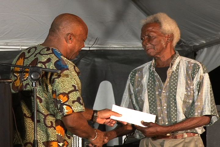 Minister of Culture on Nevis Hon. Hensley Daniel acknowledges Culturama patron and Grand Marshal for the Cultural Parade Mr. Elmos Jeffers